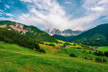 The Odle mountain peaks and the church of Santa Maddalena. Sankt Maddalena, Val di Funes in Italy.