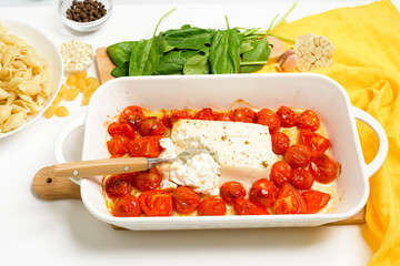 step-by-step preparation and ingredients for oven-baked feta cheese with tomatoes and pasta, pepper...