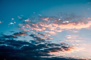 Fototapeta na wymiar Pink clouds in blue sky at sunset