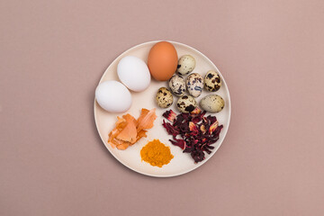 Natural dye for Easter eggs. Ingredients for home dyeing of eggs with environmentally friendly dyes, hibiscus tea, egg husks, turmeric. View from above