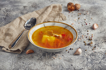 Light soup in chicken broth, with noodles and spices on a light background