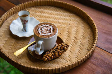 Fresh coffee in civet glass placed on a rattan tray