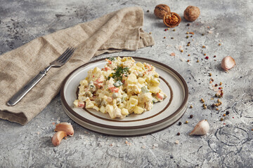 Traditional salad Russian cuisine Olivier, light background