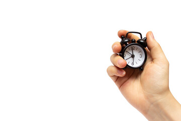 Creative idea about time. Black alarm clock in a female hand.