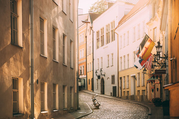 Tallinn, Estonia. Empty Puhavaimu Street In Old Town During Sunset. Motorcycle Parked On Old Street