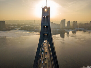 North bridge in Kiev at sunset. Aerial drone view. Spring evening, the sun's rays pass through the...