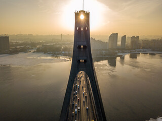 North bridge in Kiev at sunset. Aerial drone view. Spring evening, the sun's rays pass through the...