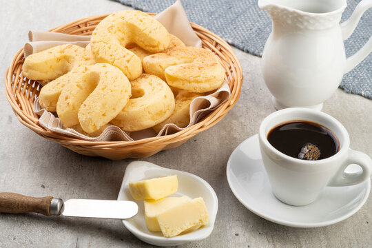 Chipas, typical south american cheese bun in a basket with butter and coffee