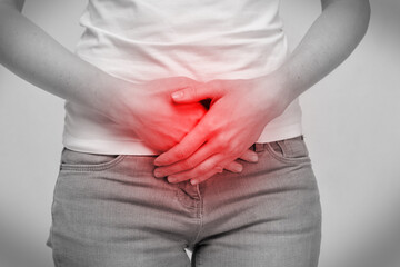 Person woman feels pain in the lower abdomen intestines