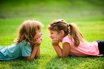 Kids couple in love. Two children on spring field. Adorable happy child outdoors on sunny day.