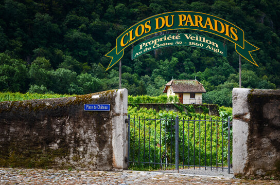 Aigle, Switzerland - July 11, 2020: Stone wall and entrance of the Clos du Pararadis, important vineyard of the Cave Veillon, historical winery of the village of Aigle, Switzerland, on July 11, 2020