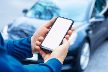 Mock-up of a smartphone in the hands of a man against the background of a car.