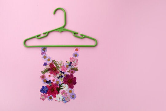 Spring sale concept with colorful flowers on pink background. Flat lay, top view.