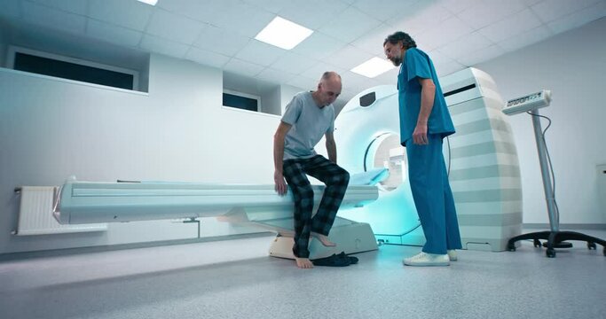 Doctor inviting patient to CT machine