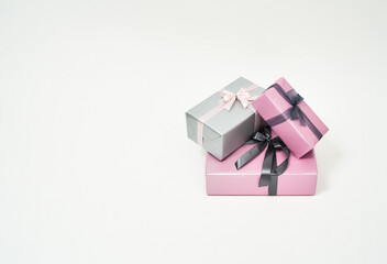 Womens day. Three colorful wrapped gift boxes with bows against white background, copy space for text about sales and discounts