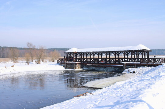 wooden bridge over the Suprasl river in Suprasl in Podlasie, Poland in a winter, snowy scenery