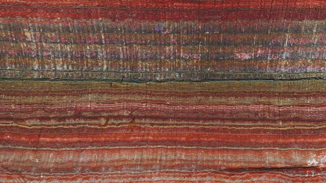 Moving of underground multicolor background fragment with traces of large drilling equipment on wall in potassium and sodium salts