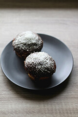 Two large homemade muffins with chocolate and coconut topping. Selective focus.