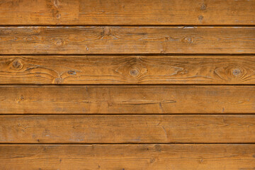 Closeup of texture of weathered varnished wooden wall. Aged wooden plank fence. Copy space
