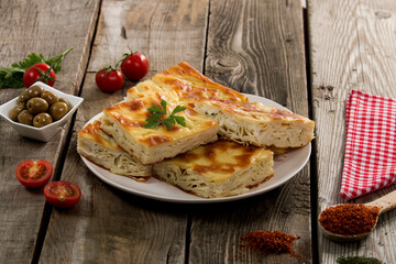 Water pastry on the plate. Composition of water pastry, tomato, hot pepper and olives on old wooden table.