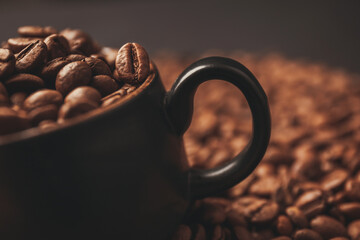 Coffee cup full with coffee beans, close up shoot. Coffee background concept. `Shallow depth of field on coffee bean in cup. 