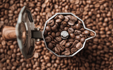 Top view on mocha pot full with coffee beans. Coffee background concept.