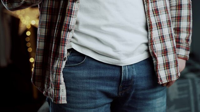 Caucasian man hand close-up takes out condom in gold package from jeans pocket. Sex theme with protection. Safe sex. Prevention of sexually transmitted diseases, infections, aids. Healthcare