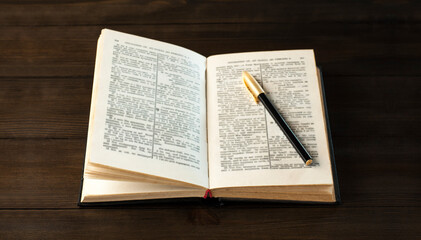 Open holy bible book on the table. Scripture. A pen