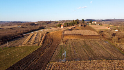 Arial drone view of freshly plowed field ready for new planting and seeding season. Growing winter wheat. Winter crops on arable land. Colorful field.