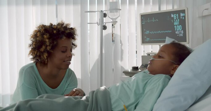 Afro-american mother talking to daughter in intensive care unit