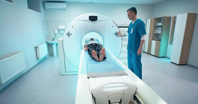 Male doctor and patient finishing CT scan