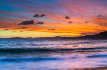 Naklejka na ściany i meble Sunset and clouds at the seaside