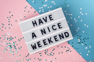 Have a nice weekend - text on display lightbox on blue and pink background. - obrazy, fototapety, plakaty
