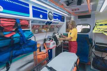 young health woman prepares an ambulance