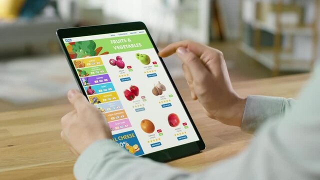 Person Uses Tablet Computer with Touch Screen, Browsing through Online Food Delivery Market, Choosing Vegetables in Fresh Goods Section