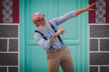 an older man in hipster clothes and glasses and a long white beard focus on head