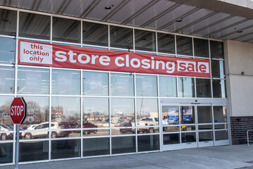 Store Closing and huge discount signs displayed at a soon to be out of business clearance sale....