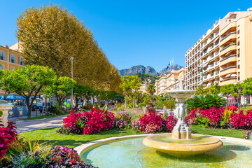 The Alpes Maritimes mountains rise behind the Jardins Bioves in the city center of the seaside...