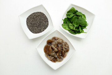 On a white background, three white plates with different options for vegetable protein for vegetarians.
