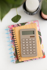 Basic calculator on a pile of financial notebooks.