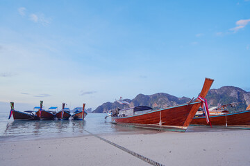Travel by Thailand. Landscape with traditional longtail fishing boat on the sea beach.