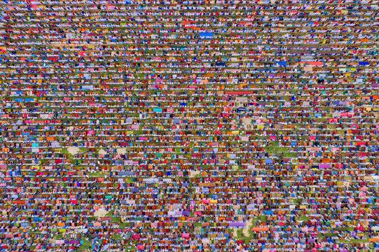 Aerial view of a vast crowd of people worshipping at Gore Shahid park in front of Eid Gah Minar religious site in Dinajpur, Rangpur, Bangladesh.