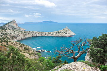 Fototapeta na wymiar The Black Sea coast near Novy Svet, South-Eastern Crimea. View of Mount Koba-Kaya, Cape Kapchik and Sky-Blue Bay.