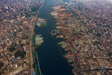 Aerial view of Dhaka skyline city centre along Buriganga river with Gol Talab artificial lake in foreground, Dhaka, Bangladesh.