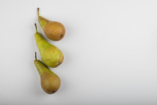 Three whole green pears isolated on white background