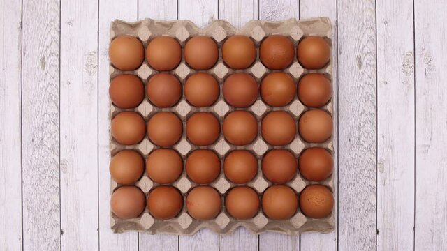 Eggs appear n box for eggs on wooden theme. Stop motion