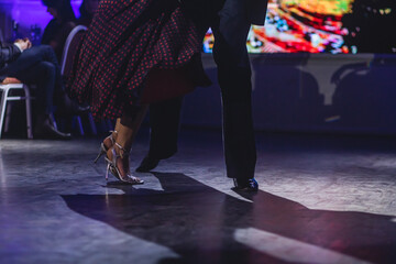 Fototapeta na wymiar Dancing shoes of young couple, Couples dancing traditional latin argentinian dance milonga in the ballroom, tango salsa bachata kizomba lesson, dance festival, wooden floor, close up view of shoes