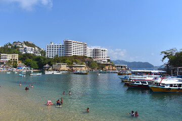 A view of Caleta beach, it can see Boats and Hotels