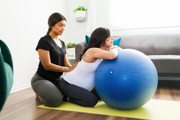Midwife rubbing the back of a pregnant woman