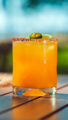 detail of Refreshing drink or cocktail with ice and lemon in glass on table on sunny day in front of the sea, Guanacaste Costa Rica